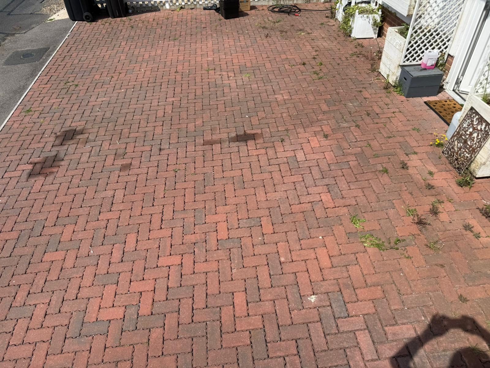 Weedy, faded block-paving driveway before cleaning